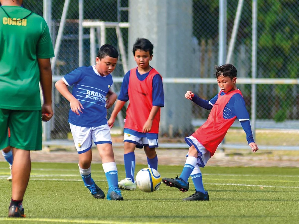 Children building movement and teamwork through soccer