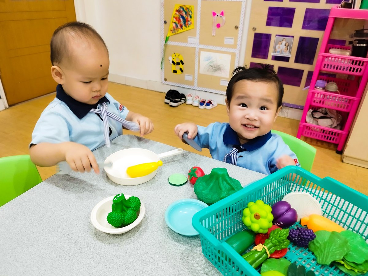 Young children developing imagination through pretend play at Tutor Time Intercon